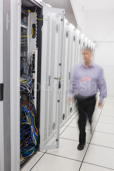 Man walking towards open server tower Stock photo © wavebreak_media