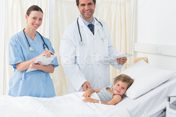 Doctors with sick girl in hospital ward Stock photo © wavebreak_media