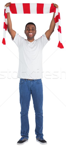 Happy football fan waving scarf Stock photo © wavebreak_media