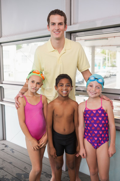 Swimming coach with his students poolside Stock photo © wavebreak_media