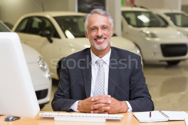 Smiling businessman sitting at his desk Stock photo © wavebreak_media