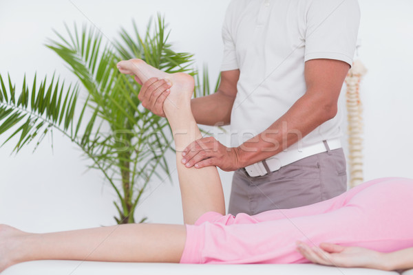 Stock photo: Physiotherapist doing leg massage to his patient