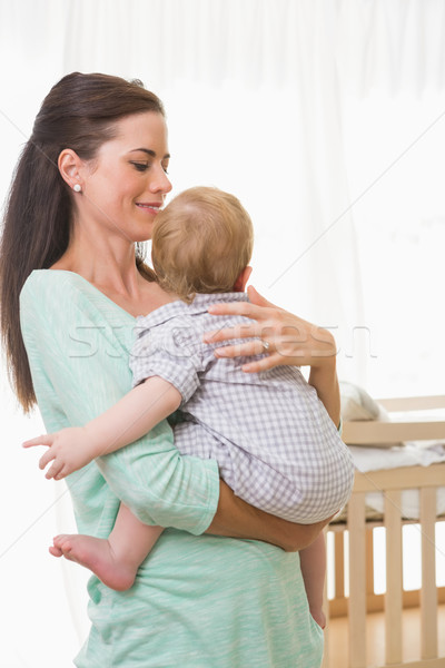 Happy mother holding baby boy Stock photo © wavebreak_media