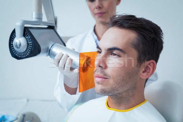 Serious young man undergoing dental checkup Stock photo © wavebreak_media