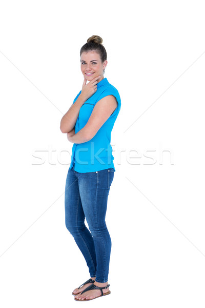 Happy pretty casual brunette looking at camera with hands on chi Stock photo © wavebreak_media