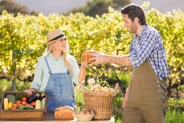 Happy farmer couple handing bread Stock photo © wavebreak_media