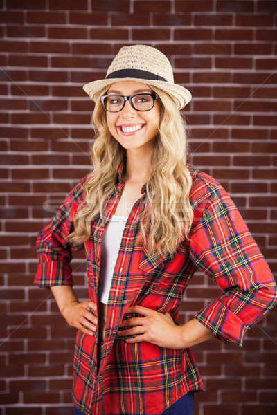 Gorgeous smiling blonde hipster with hands on hips Stock photo © wavebreak_media