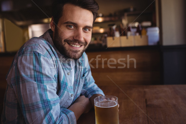 Portrait of happy man having beer Stock photo © wavebreak_media