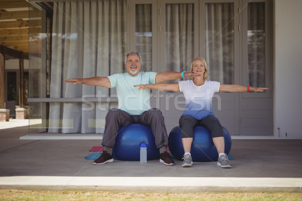 Senior couple doing stretching exercise on exercise ball Stock photo © wavebreak_media