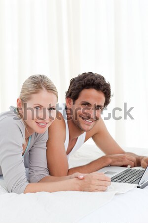 Romantic couple drinking coffee lying on their bed Stock photo © wavebreak_media