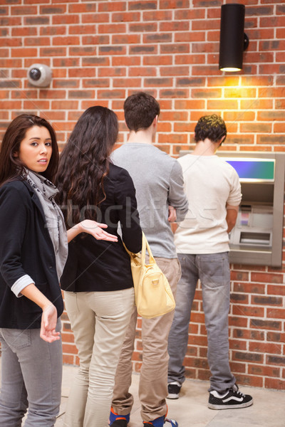 Portrait of an impatient woman queuing at an ATM Stock photo © wavebreak_media