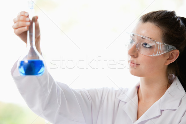 Beautiful scientist looking at a flask in a laboratory Stock photo © wavebreak_media