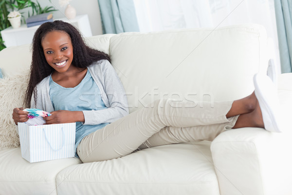 Smiling woman taking a rest on the sofa after shopping Stock photo © wavebreak_media