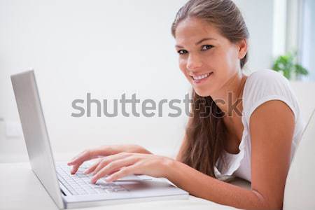 Stock photo: Side view of young woman on her laptop