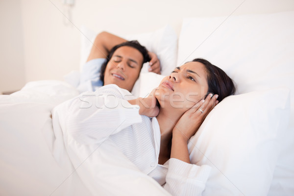 Young woman can't sleep next to her snoring boyfriend Stock photo © wavebreak_media