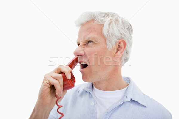 Angry man making a phone call against a white background Stock photo © wavebreak_media