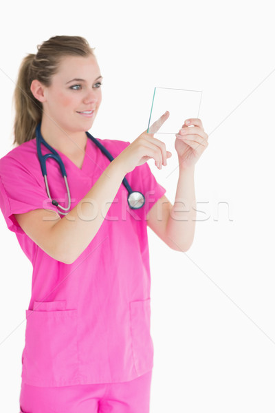 Joyful doctor touching pane while viewing it Stock photo © wavebreak_media