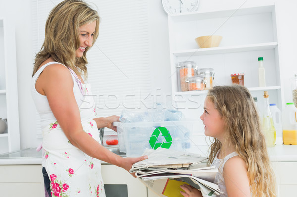 Mother taking newspaper from daughte for recycling Stock photo © wavebreak_media
