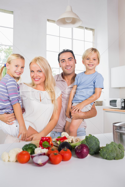 Stock photo: Smiling parents bearing their offspring