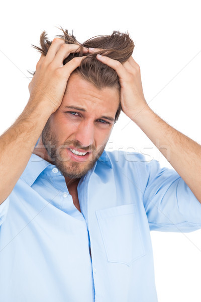 Stock photo: Tanned stressed man holding his hair