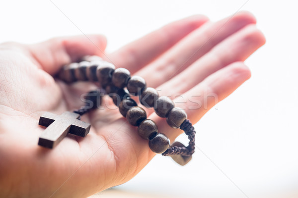 Hand holding wooden rosary beads Stock photo © wavebreak_media