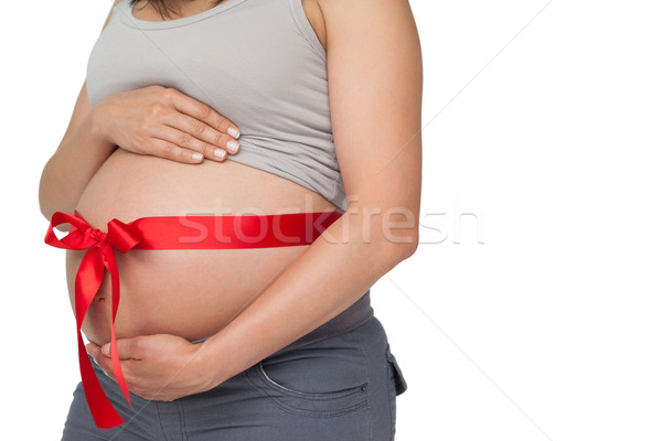 Terhes nő piros íj körül dudorodás fehér Stock fotó © wavebreak_media