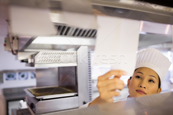 Female chef going through cooking checklist at kitchen Stock photo © wavebreak_media