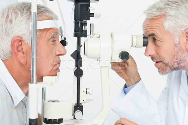 Optometrist doing sight testing for senior patient Stock photo © wavebreak_media