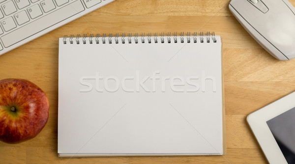 Stock photo: Overhead of notepad and technology 