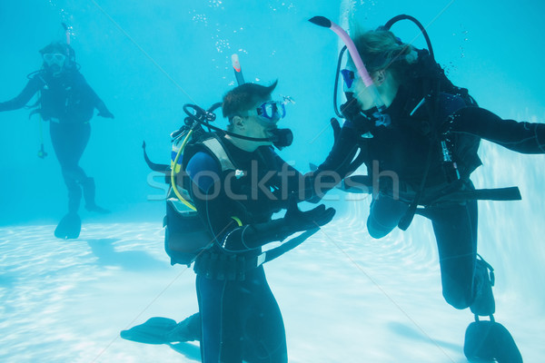 Stock photo: Friends on scuba training submerged in swimming pool 