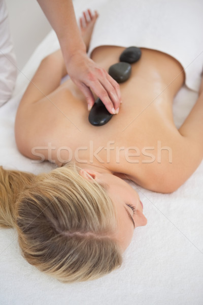 Stock photo: Beautiful blonde enjoying a hot stone massage 