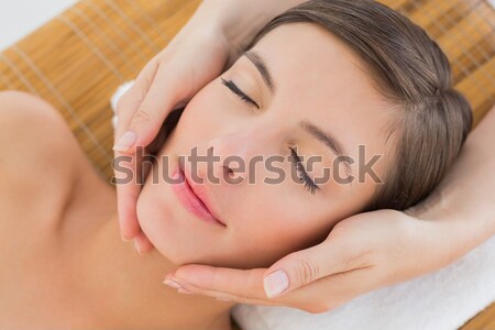 Attractive woman receiving facial massage at spa center Stock photo © wavebreak_media