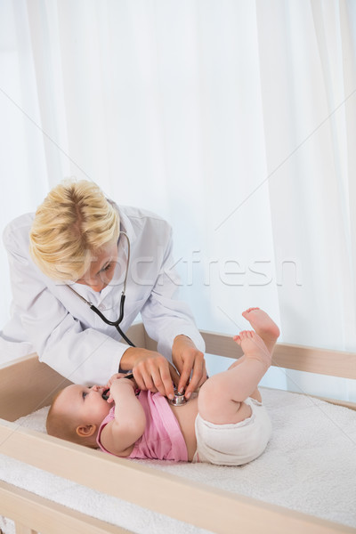 Beautiful cute baby girl with blonde doctor using stethoscope Stock photo © wavebreak_media