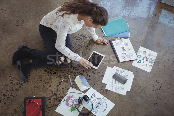 Graphic designer with digital table working on floor Stock photo © wavebreak_media