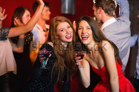 Portrait of female friends with disposable cups in club Stock photo © wavebreak_media