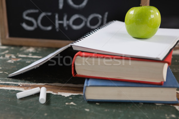 Books, apple and slate board with back to school text Stock photo © wavebreak_media