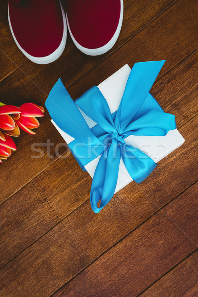Stock photo: View of sneakers and blue gift