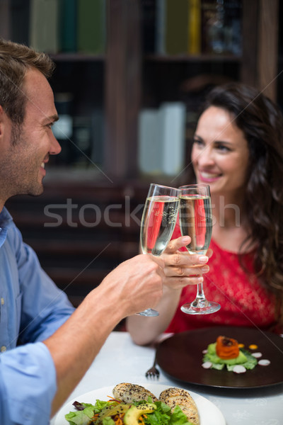 Heureux couple champagne flûtes restaurant [[stock_photo]] © wavebreak_media