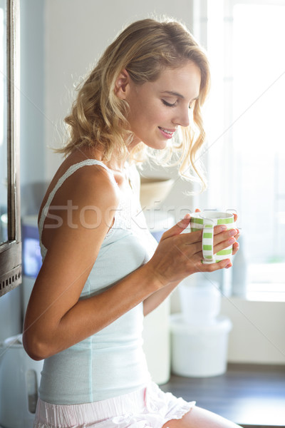Beautiful young woman having coffee at home Stock photo © wavebreak_media