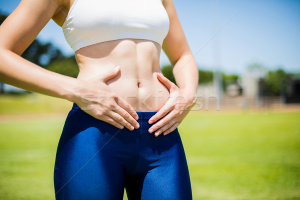 Mid-section of female athlete touching her belly Stock photo © wavebreak_media