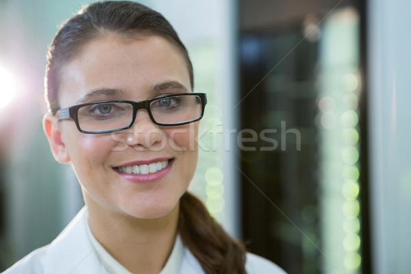 Optometrist in spectacles smiling in optical store Stock photo © wavebreak_media