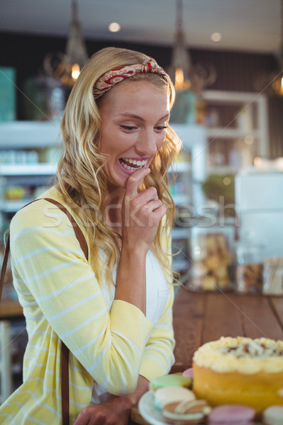 Stock photo: Smiling woman looking at dessert