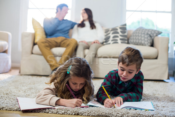 Children doing homework with parents in background Stock photo © wavebreak_media