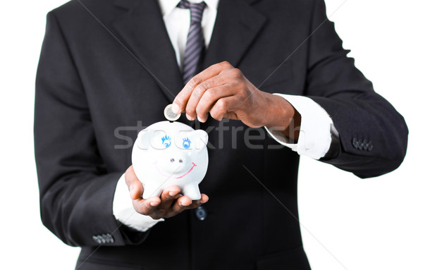 Close-up of a Businessman putting money in his piggy bank  Stock photo © wavebreak_media