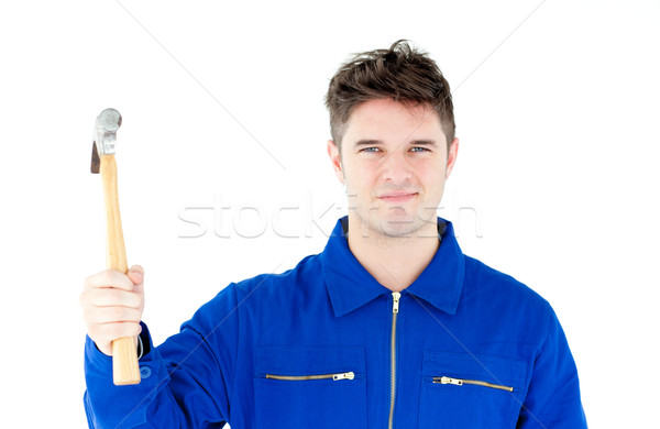 Smiling mechanic holding a hammer looking at the camera against white background  Stock photo © wavebreak_media