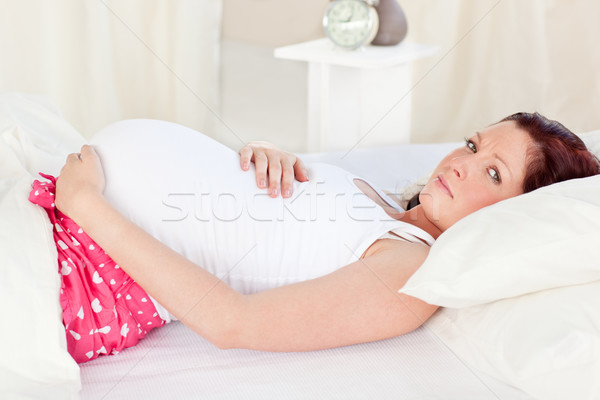 Caucasian pregnant woman resting n her bed in the bedroom at home Stock photo © wavebreak_media