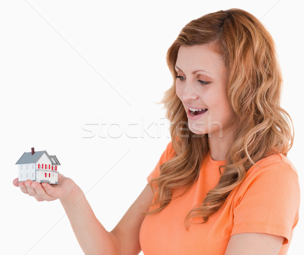 Young woman holding an house model on a white background Stock photo © wavebreak_media