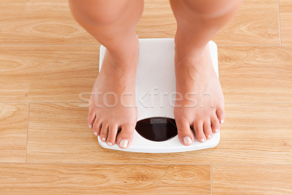 Close up of legs on a weighing machine Stock photo © wavebreak_media