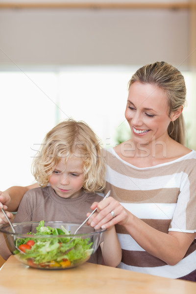 Mother and son stirring salad together Stock photo © wavebreak_media