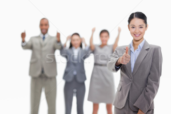 Happy businesswoman approving with her co-workers in the background Stock photo © wavebreak_media